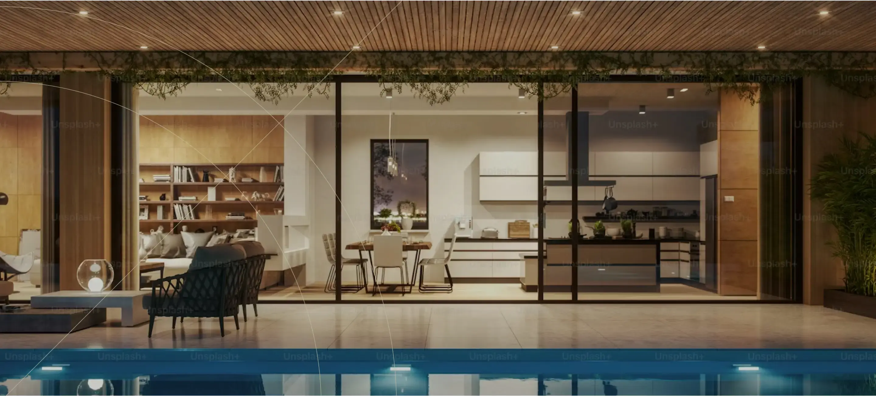 Luxurious modern home with large glass walls opening to a poolside terrace